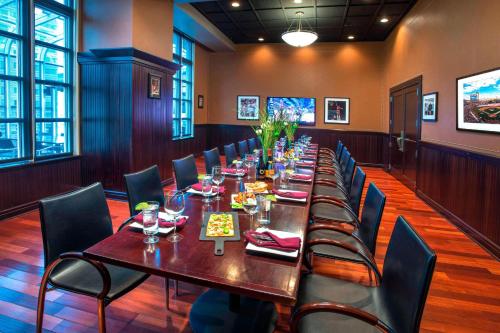 a long dining room with a long table and chairs at Marriott Philadelphia West in West Conshohocken