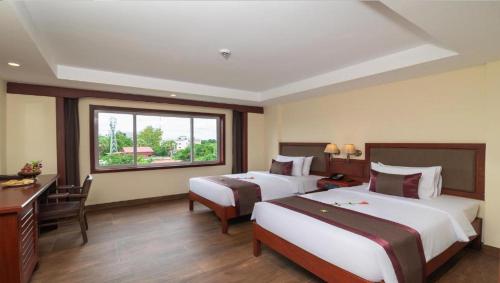 Postel nebo postele na pokoji v ubytování Hotel De La Renaissance