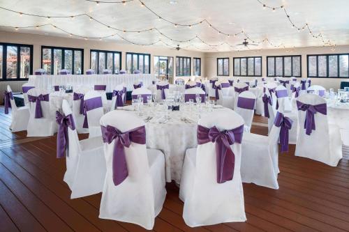 a room with white tables and chairs with purple bows at Fort Collins Marriott in Fort Collins