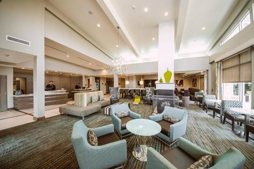 a large lobby with couches and tables and a waiting room at Residence Inn by Marriott Harlingen in Harlingen