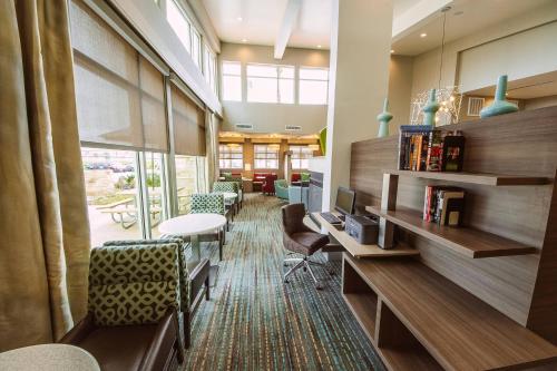 a lobby with a desk with a computer and chairs at Residence Inn by Marriott Harlingen in Harlingen