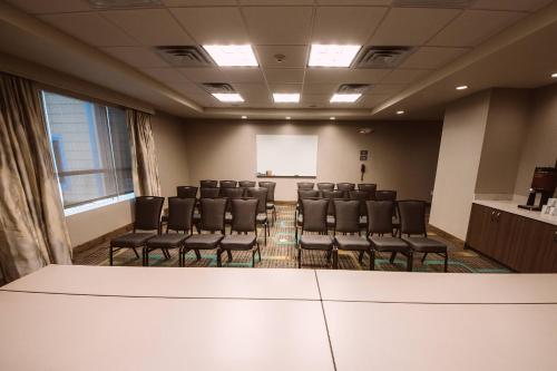 a conference room with chairs and a white screen at Residence Inn by Marriott Harlingen in Harlingen