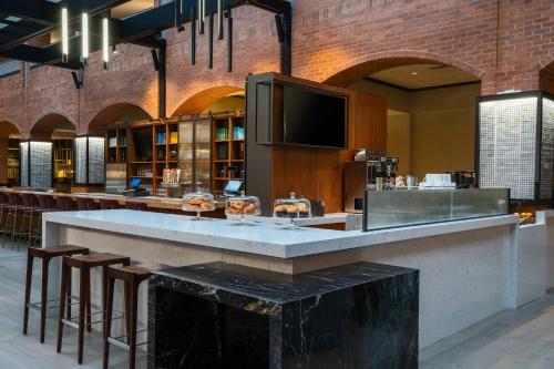 a large bar in a building with stools at Philadelphia Marriott Old City in Philadelphia