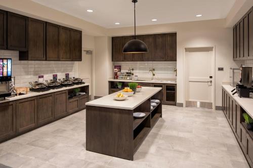 a large kitchen with wooden cabinets and a island in it at Residence Inn by Marriott Boise Downtown City Center in Boise
