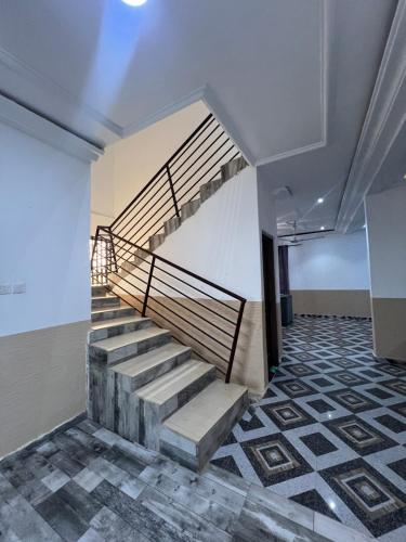 a staircase in a room with a tiled floor at Citrus Duplex Getaway in Dawhwenya