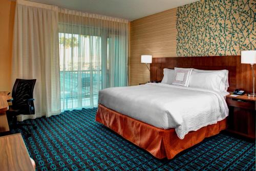 a hotel room with a bed and a large window at Fairfield Inn & Suites by Marriott Los Angeles LAX/El Segundo in El Segundo