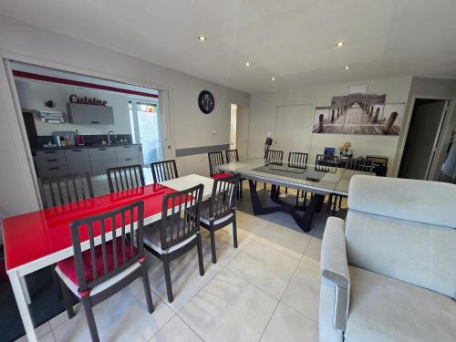 une salle à manger avec une table et des chaises rouges dans l'établissement Logement Entier, à Saint-Jean-Lachalm