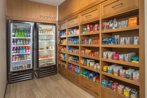 a store aisle with a refrigerator and lots of food at Residence Inn by Marriott Baltimore at The Johns Hopkins Medical Campus in Baltimore
