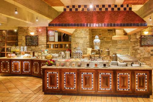 a large kitchen with a counter in a restaurant at Marriott Puebla Hotel Meson del Angel in Puebla