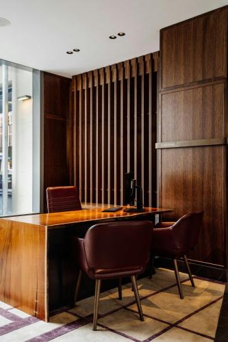 an office with a wooden desk and two chairs at The Tasman, a Luxury Collection Hotel, Hobart in Hobart