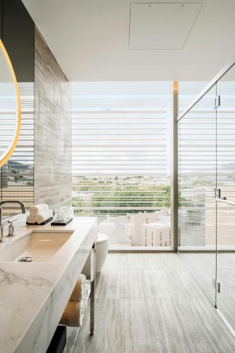 a bathroom with a sink and a large window at The Tasman, a Luxury Collection Hotel, Hobart in Hobart