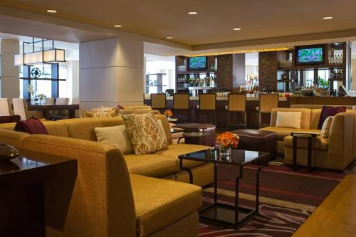 a hotel lobby with couches and a bar at Peoria Marriott Pere Marquette in Peoria