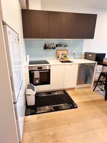 a kitchen with a sink and a stove top oven at Auckland Birkenhead BNB in Auckland