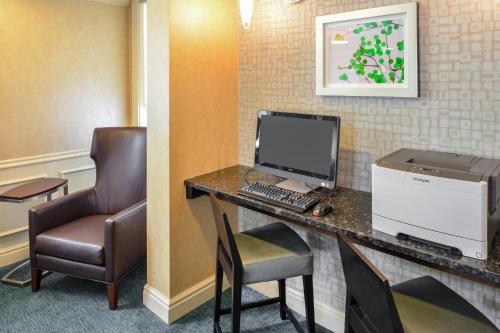 a room with a desk with a computer and a chair at Residence Inn Baltimore White Marsh in Baltimore