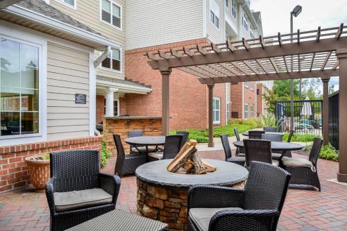 a patio with tables and chairs under a pergola at Residence Inn Baltimore White Marsh in Baltimore
