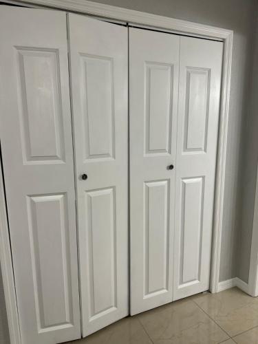 two white closet doors in a room at Sunshine guesthouse in Mulberry