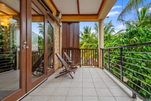 an open balcony with a chair on a porch at Buttonwood Belize in Hopkins