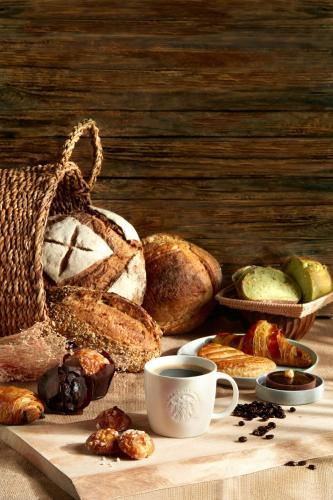 a table with various types of bread and a cup of coffee at Four Points by Sheraton Singapore, Riverview in Singapore