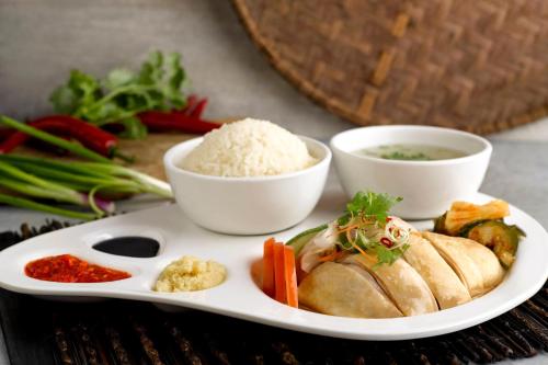a plate of food with rice and vegetables on a table at Four Points by Sheraton Singapore, Riverview in Singapore