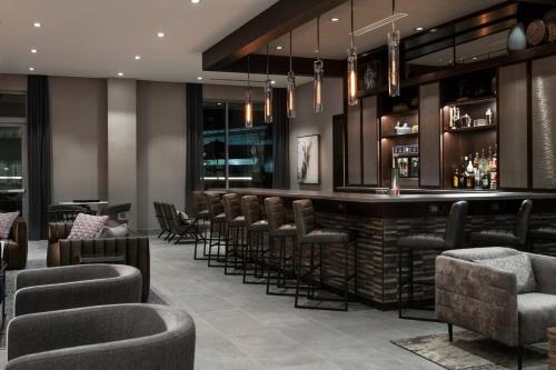 a bar in a hotel with chairs and a counter at Residence Inn by Marriott Boston Natick in Natick
