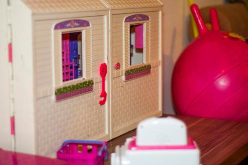 a toy house with two windows and a pink ball at Penzión ZIVKA in Závažná Poruba