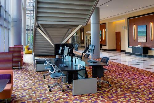 a lobby with desks and chairs in a building at JW Marriott Grand Rapids in Grand Rapids