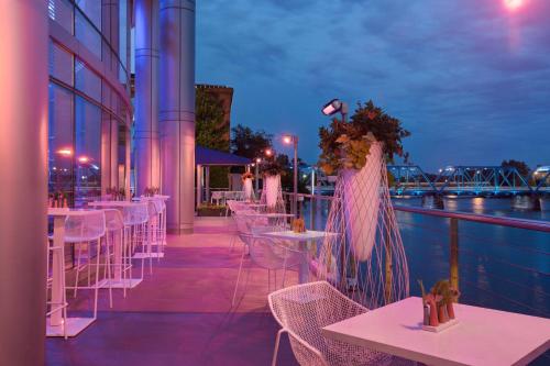 a row of tables and chairs on a balcony at night at JW Marriott Grand Rapids in Grand Rapids