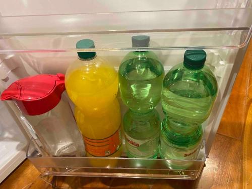 a refrigerator filled with four bottles of drinks at Dromane Lodge self-catering apartment eircode V94HR5C in Limerick