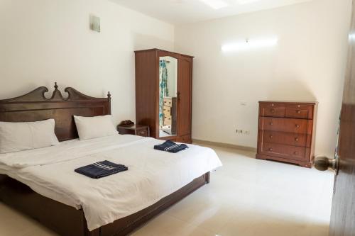 A bed or beds in a room at 2BHK Apartment with Pool access
