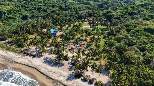 an aerial view of a beach with a resort at CASA DE CAMPO CASTILLETE dentro del PARQUE TAYRONA in El Zaino