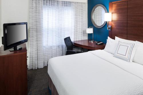 a hotel room with a bed and a television at Residence Inn Boston Marlborough in Marlborough