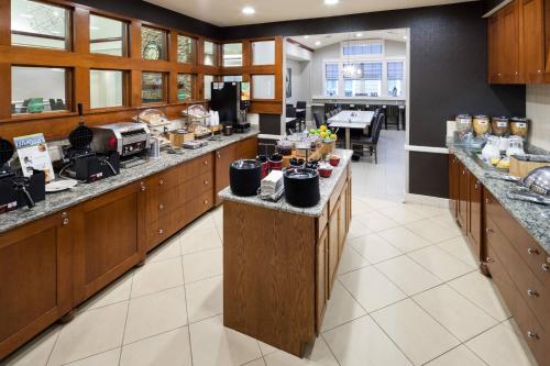a large kitchen with wooden cabinets and counter tops at Residence Inn Boston Marlborough in Marlborough