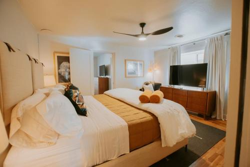 a bedroom with a bed with two teddy bears on it at Grandma's Old Town Adobe House! Hot Tub & Pet Friendly & No Pet Fee! in Albuquerque