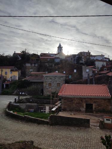 a view of a city with a clock tower in the background at Casa Iris Cunqueiros in Sobreira Formosa