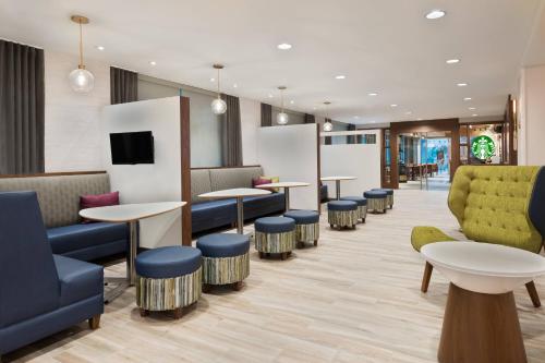 a waiting room with tables and chairs at Residence Inn by Marriott Buffalo Downtown in Buffalo