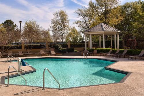 a swimming pool with a gazebo in a yard at Greenville Marriott in Greenville