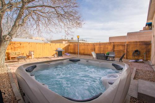 a hot tub in a backyard with a fence at Grandma's Old Town Adobe House! Private Hot Tub-Close to Old Town-Pet Friendly-No Pet Fee! in Albuquerque