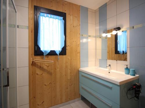 a bathroom with a sink and a mirror and a window at Chalet Mont-Dore 110m², 10 pers, parking, animaux admis - FR-1-608-280 in Mont-Dore
