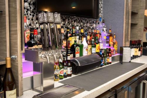a bar with a bunch of bottles of alcohol at Residence Inn by Marriott Cleveland Avon at The Emerald Event Center in Avon