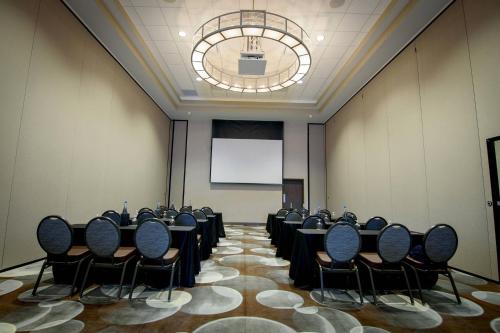 a conference room with tables and chairs and a screen at Residence Inn by Marriott Cleveland Avon at The Emerald Event Center in Avon