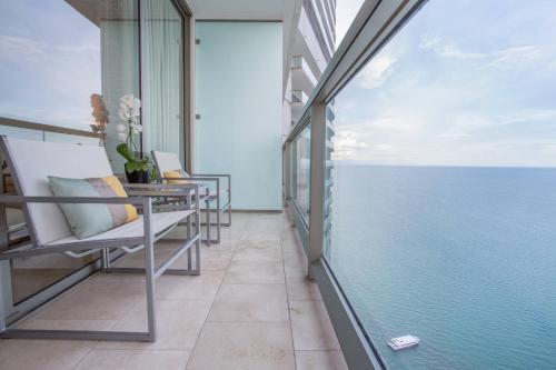 a balcony with a view of the ocean at JW Marriott Panama in Panama City