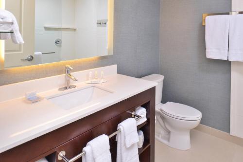 a bathroom with a sink and a toilet at Residence Inn by Marriott Cedar Rapids South in Cedar Rapids