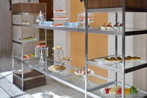 a display case filled with different types of desserts at Dead Sea Marriott Resort & Spa in Sowayma