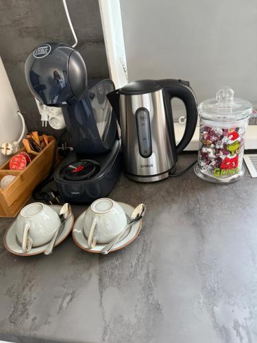a coffee pot and plates on a counter at Garsoniera de lux cu balcon in Craiova