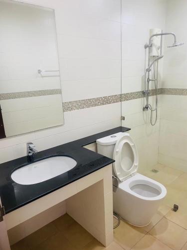 a bathroom with a sink and a toilet and a mirror at Phuket Mali house in Ban Sam Kong
