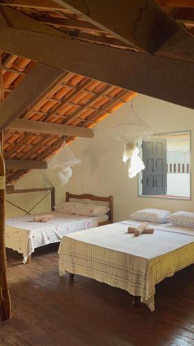 a bedroom with two beds in a room at Casa Ori Lar Boipeba in Ilha de Boipeba