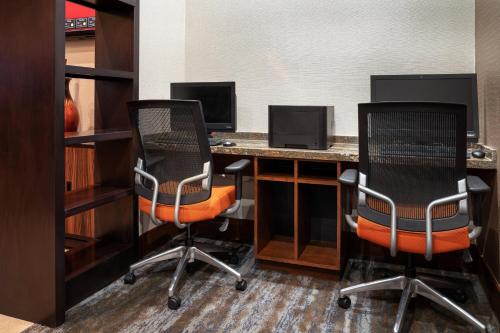 an office with two chairs and a desk with a computer at Marriott Riverside at the Convention Center in Riverside
