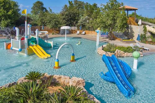 a pool with a water park with slides at The Romanos, a Luxury Collection Resort, Costa Navarino in Romanós