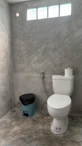 a bathroom with a white toilet and a window at Think Koh Tao in Koh Tao