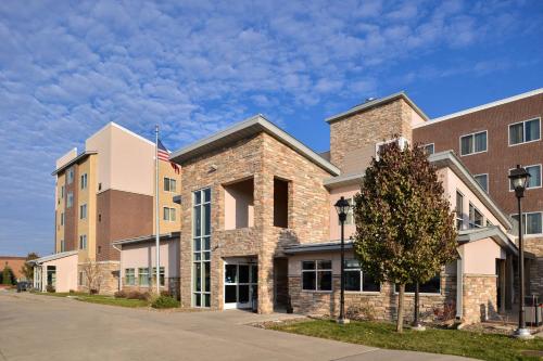 a brick building with an american flag in front of it at Residence Inn by Marriott Coralville in Coralville